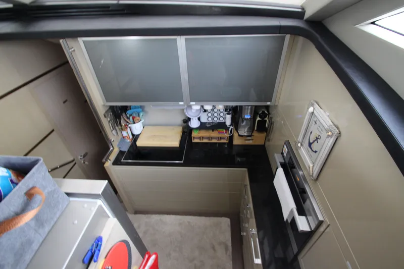  Yacht Photos Pics Compact kitchen area in 2007 Uniesse 70 Sport yacht with modern appliances and storage.