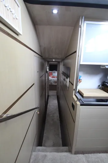  Yacht Photos Pics Interior hallway of 2007 Uniesse 70 Sport yacht, featuring modern design and compact layout.