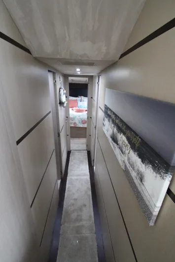  Yacht Photos Pics Interior hallway of 2007 Uniesse 70 Sport yacht, featuring modern design and artwork.