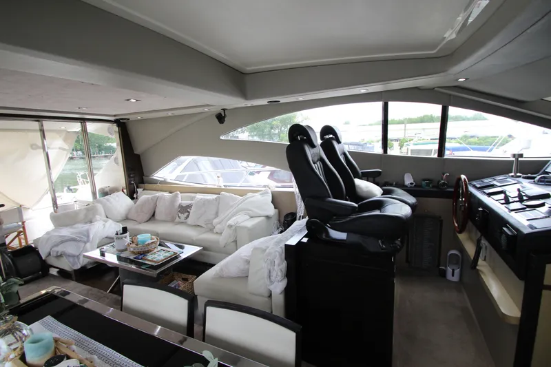  Yacht Photos Pics Luxurious interior of 2007 Uniesse 70 Sport yacht with plush seating and modern helm.