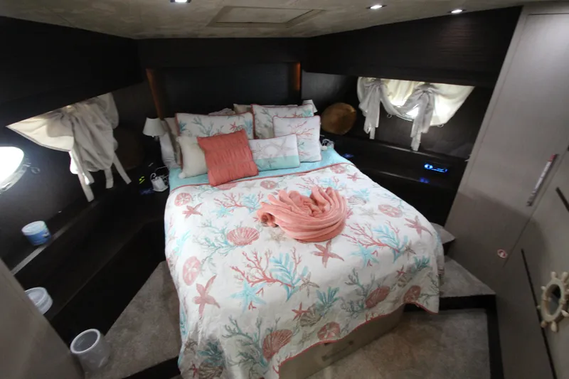  Yacht Photos Pics Luxurious bedroom in 2007 Uniesse 70 Sport yacht with nautical-themed bedding.