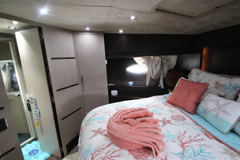  Yacht Photos Pics Luxurious bedroom interior of 2007 Uniesse 70 Sport yacht with elegant bedding and modern lighting.