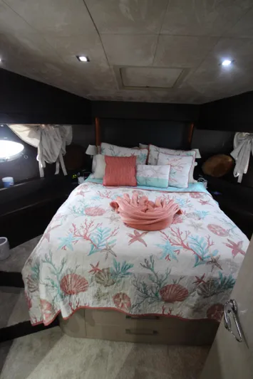  Yacht Photos Pics Luxurious bedroom in 2007 Uniesse 70 Sport yacht with coral-themed bedding.