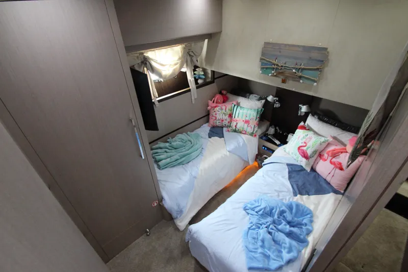  Yacht Photos Pics Cozy twin bedroom in 2007 Uniesse 70 Sport yacht with colorful decor.