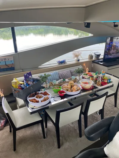  Yacht Photos Pics Luxurious 2007 Uniesse 70 Sport yacht interior with dining table set for a feast.