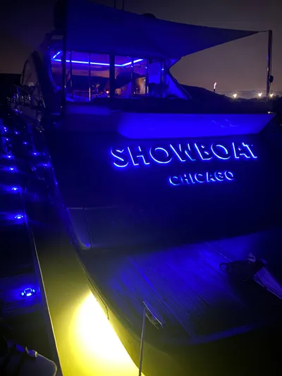  Yacht Photos Pics Uniesse 70 Sport 2007 yacht with blue neon lights, "Showboat Chicago" displayed.