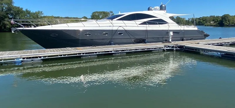  Yacht Photos Pics Luxury 2007 Uniesse 70 Sport yacht docked on calm water.