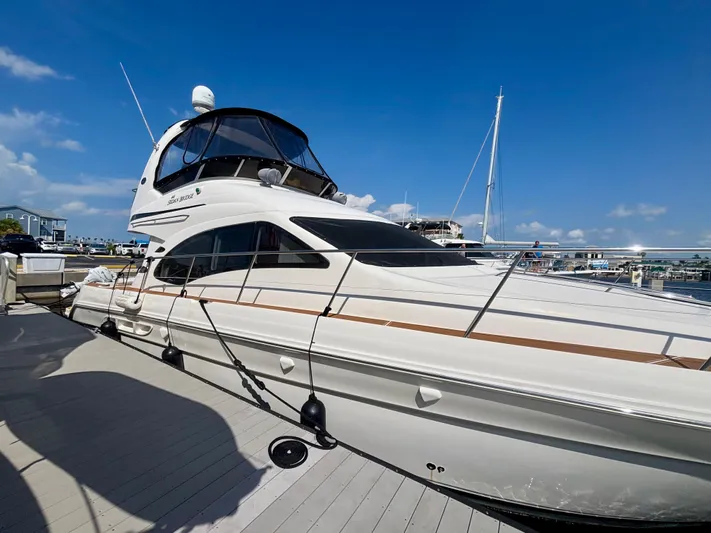  Yacht Photos Pics 2008 Sea Ray 44 Sedan Bridge yacht docked under clear blue sky.