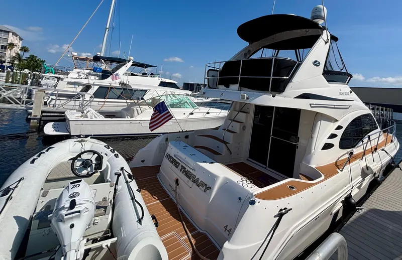  Yacht Photos Pics 2008 Sea Ray 44 Sedan Bridge yacht docked with inflatable boat nearby.