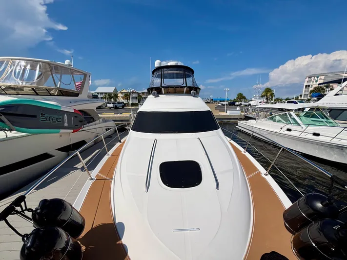  Yacht Photos Pics 2008 Sea Ray 44 Sedan Bridge yacht docked at marina under clear blue sky.