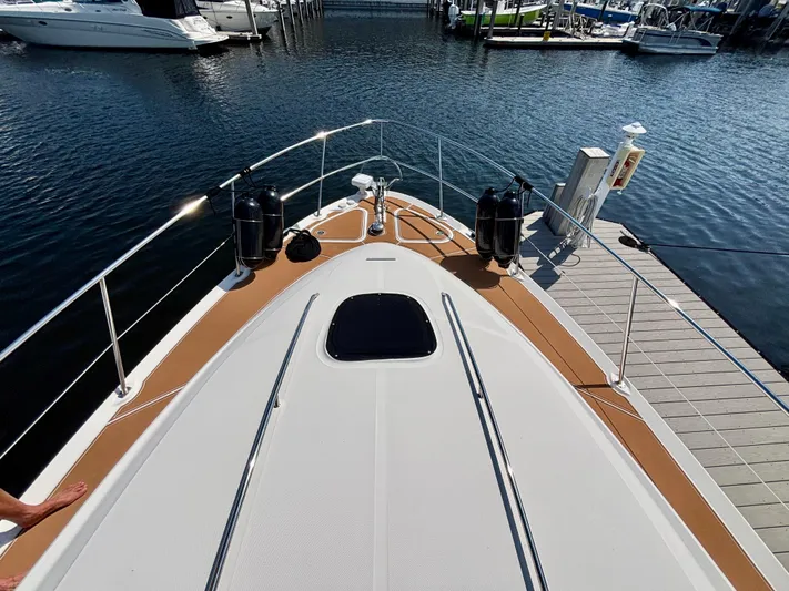  Yacht Photos Pics 2008 Sea Ray 44 Sedan Bridge yacht docked at marina, view from bow.