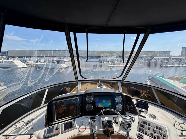  Yacht Photos Pics 2008 Sea Ray 44 Sedan Bridge helm with navigation screens, overlooking marina.