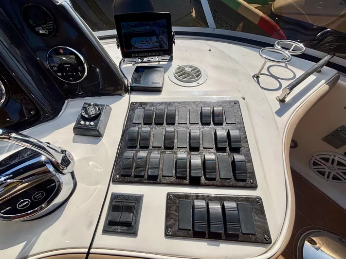  Yacht Photos Pics Control panel of a 2008 Sea Ray 44 Sedan Bridge yacht with switches and navigation screen.