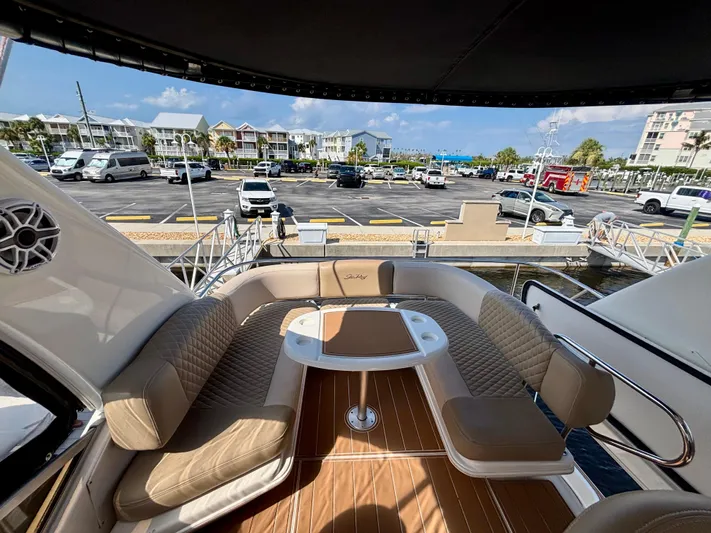  Yacht Photos Pics 2008 Sea Ray 44 Sedan Bridge yacht interior with seating and table, docked at marina.