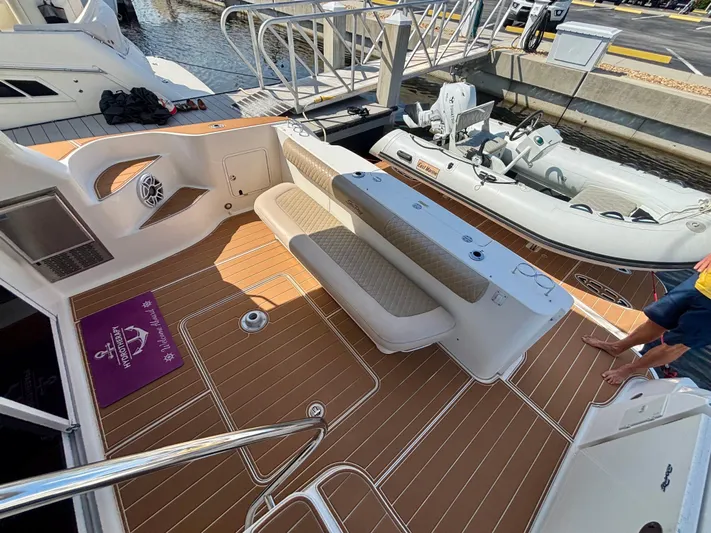  Yacht Photos Pics 2008 Sea Ray 44 Sedan Bridge yacht deck with seating and docked inflatable boat.