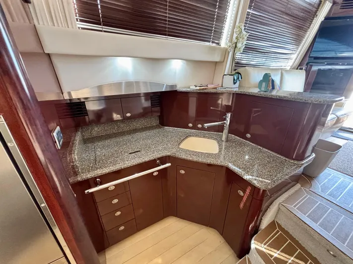  Yacht Photos Pics Luxurious kitchen interior of 2008 Sea Ray 44 Sedan Bridge yacht with granite countertops.