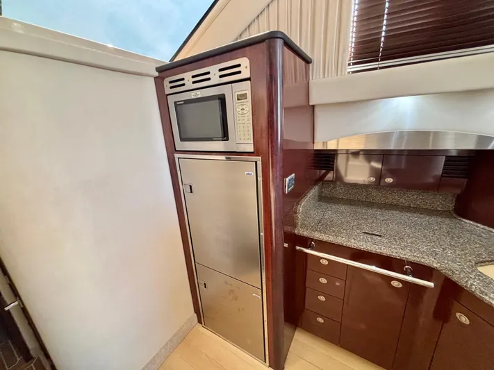  Yacht Photos Pics 2008 Sea Ray 44 Sedan Bridge kitchen with microwave and stainless steel appliances.