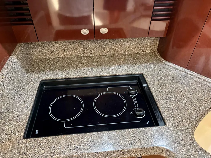  Yacht Photos Pics Granite countertop with electric stove in 2008 Sea Ray 44 Sedan Bridge yacht kitchen.