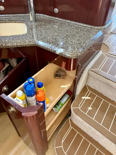  Yacht Photos Pics 2008 Sea Ray 44 Sedan Bridge interior with open cabinet and cleaning supplies.