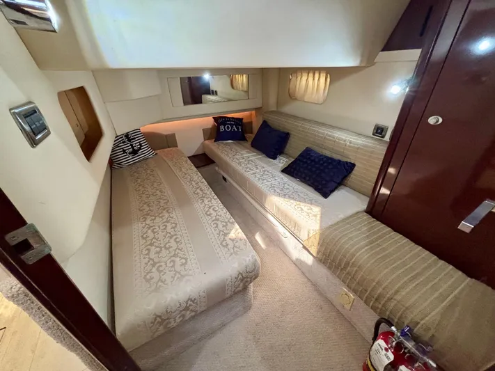  Yacht Photos Pics Interior of 2008 Sea Ray 44 Sedan Bridge with cozy twin beds and nautical decor.