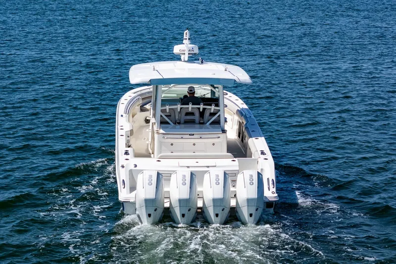  Yacht Photos Pics 2022 Boston Whaler 380 Outrage cruising on open water, rear view.
