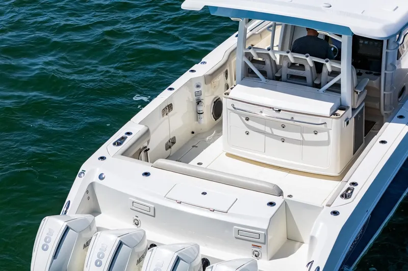  Yacht Photos Pics 2022 Boston Whaler 380 Outrage boat on water, showcasing spacious deck and seating.