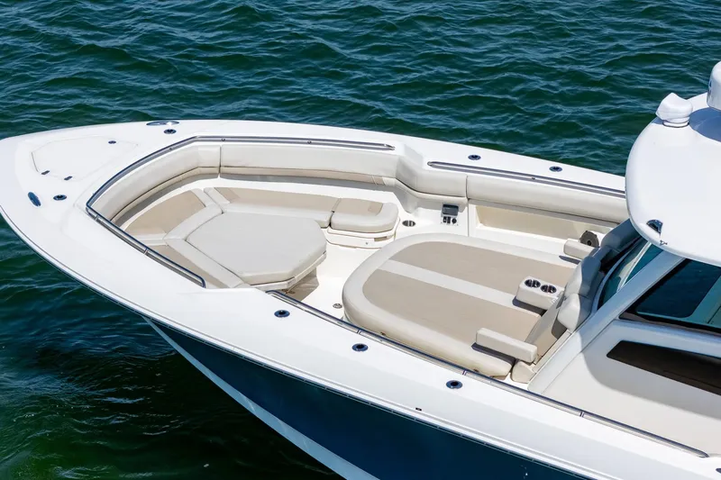  Yacht Photos Pics 2022 Boston Whaler 380 Outrage boat with spacious seating on calm water.