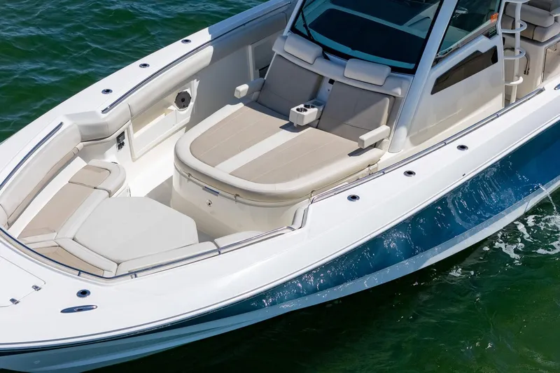  Yacht Photos Pics 2022 Boston Whaler 380 Outrage boat with spacious seating on calm water.