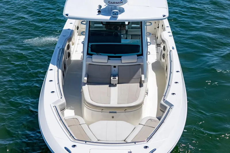  Yacht Photos Pics 2022 Boston Whaler 380 Outrage boat on water, showcasing spacious seating and sleek design.