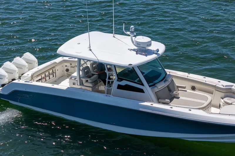  Yacht Photos Pics 2022 Boston Whaler 380 Outrage cruising on open water, showcasing sleek design and powerful engines.