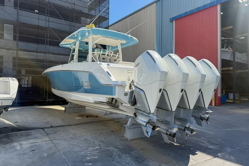 Yacht Photos Pics 2022 Boston Whaler 380 Outrage with four outboard engines, docked at a marina.