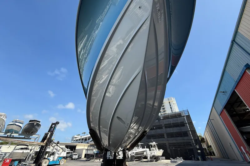  Yacht Photos Pics 2022 Boston Whaler 380 Outrage boat hull, viewed from below, in a marina setting.