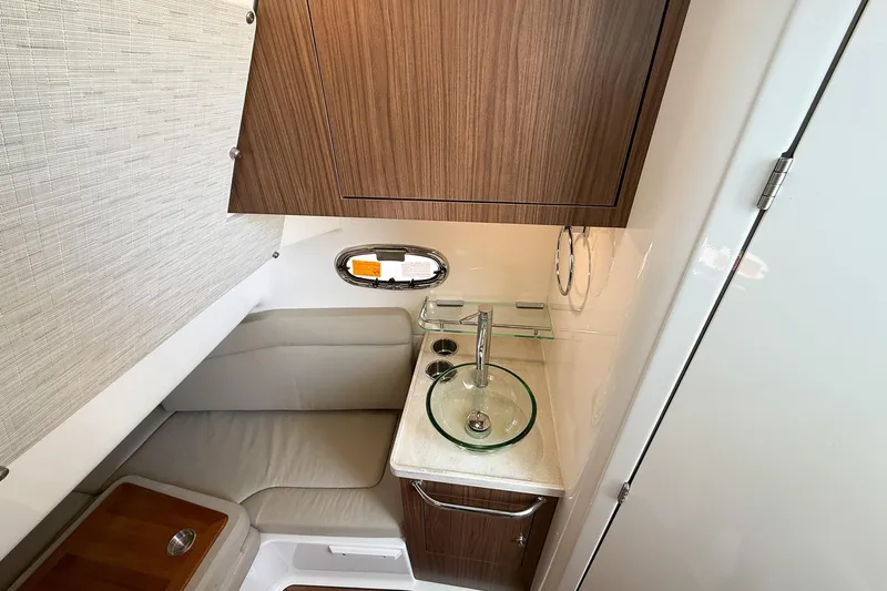  Yacht Photos Pics 2022 Boston Whaler 380 Outrage cabin with modern sink and seating area.