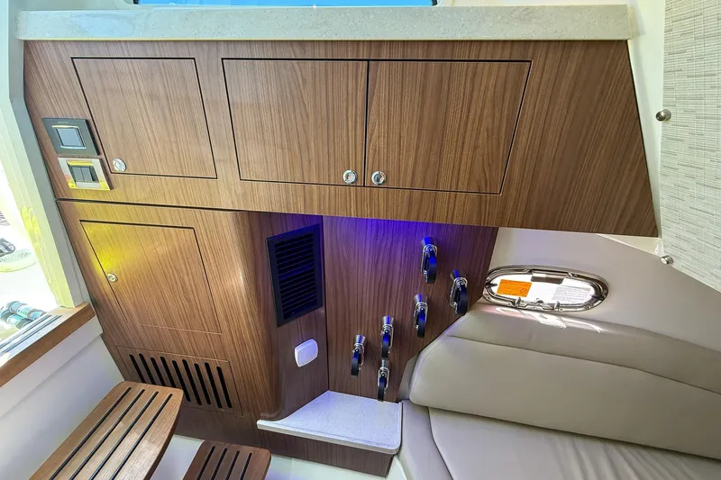  Yacht Photos Pics Interior of 2022 Boston Whaler 380 Outrage, featuring wood cabinetry and modern seating.