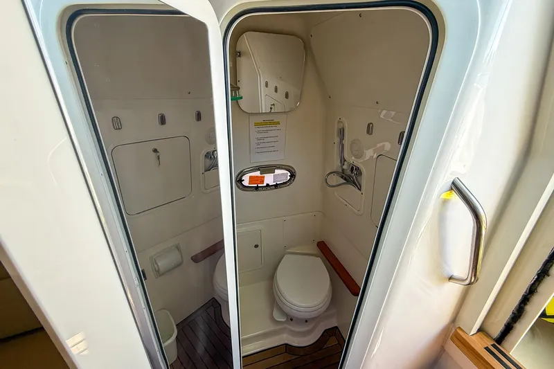  Yacht Photos Pics 2022 Boston Whaler 380 Outrage boat bathroom interior with toilet and shower.