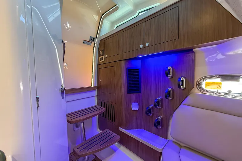  Yacht Photos Pics Interior of 2022 Boston Whaler 380 Outrage with wood accents and blue LED lighting.