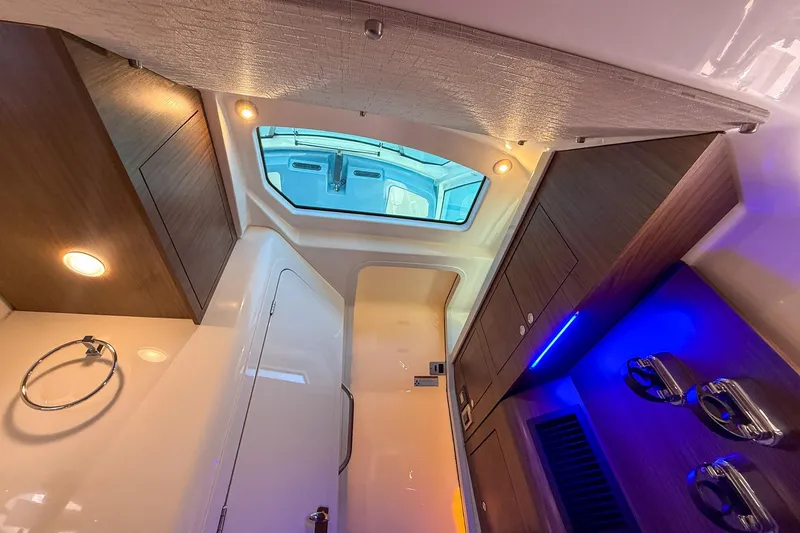  Yacht Photos Pics Luxurious interior of 2022 Boston Whaler 380 Outrage with modern lighting and wood finishes.