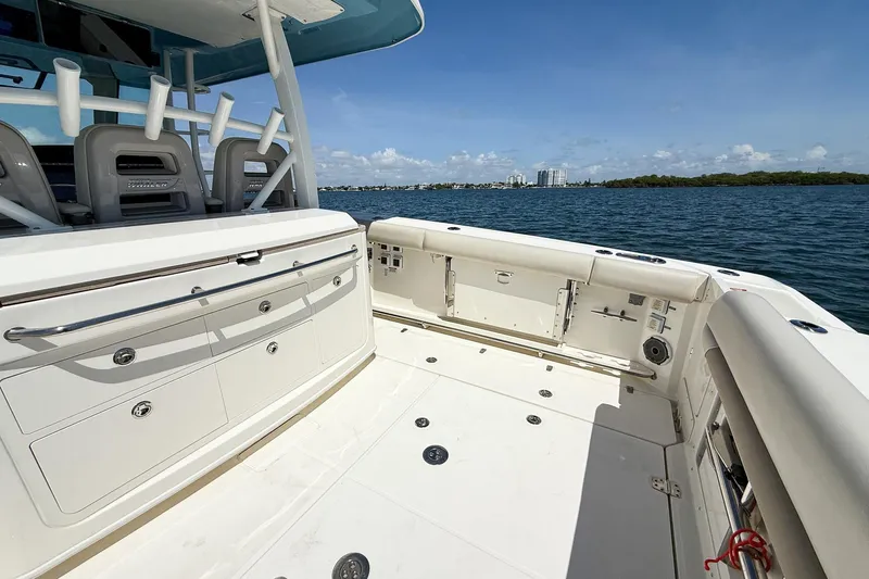  Yacht Photos Pics 2022 Boston Whaler 380 Outrage boat deck with seating, storage, and ocean view.