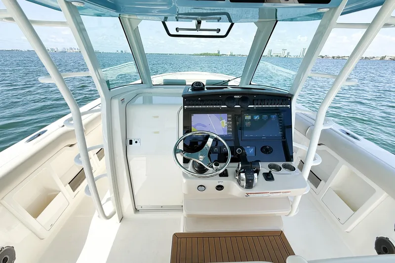  Yacht Photos Pics 2022 Boston Whaler 380 Outrage helm with advanced navigation system on open water.