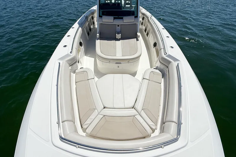  Yacht Photos Pics 2022 Boston Whaler 380 Outrage boat interior with cushioned seating on open water.