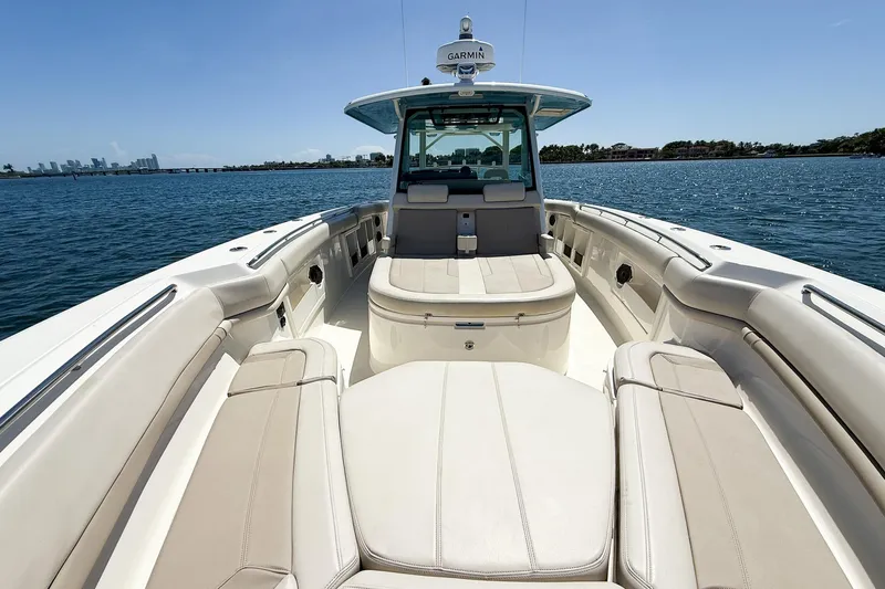  Yacht Photos Pics 2022 Boston Whaler 380 Outrage boat interior with seating, on calm water.