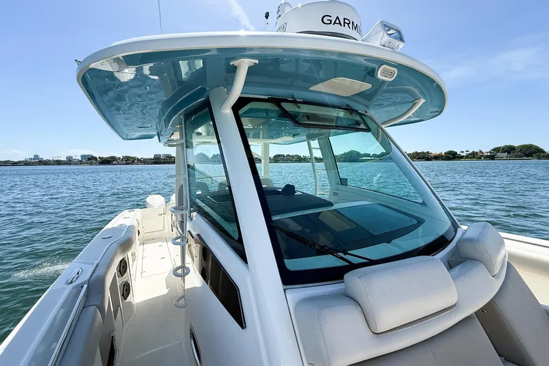  Yacht Photos Pics 2022 Boston Whaler 380 Outrage boat on calm water, featuring sleek design and advanced navigation.
