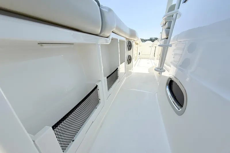  Yacht Photos Pics 2022 Boston Whaler 380 Outrage interior, featuring sleek white design and storage compartments.