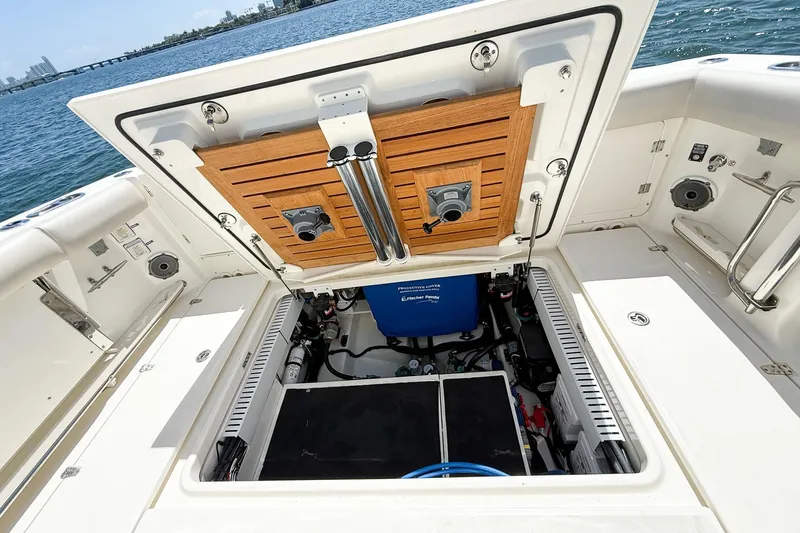  Yacht Photos Pics Boston Whaler 380 Outrage 2022 boat storage compartment open, revealing interior equipment.