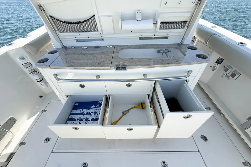  Yacht Photos Pics Boston Whaler 380 Outrage 2022 boat interior with open storage compartments and countertop.