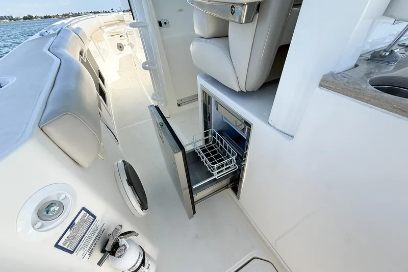  Yacht Photos Pics 2022 Boston Whaler 380 Outrage interior with open storage compartment and seating.