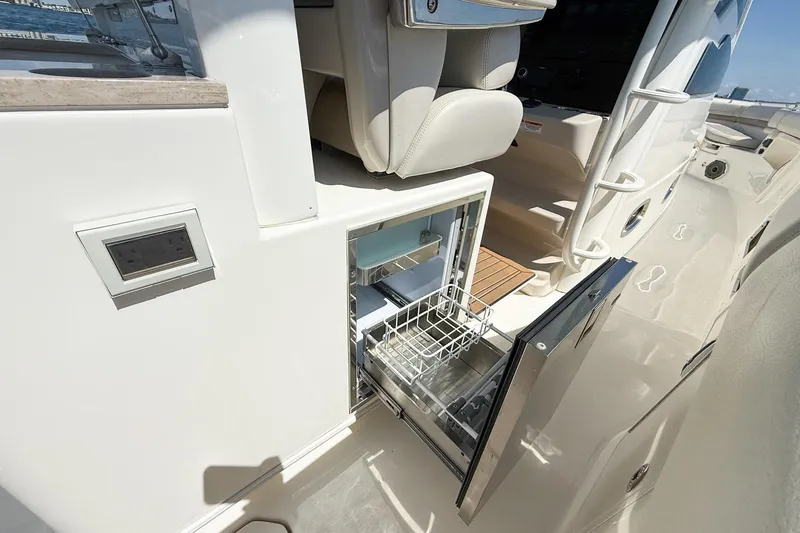  Yacht Photos Pics 2022 Boston Whaler 380 Outrage boat with open built-in storage compartment.