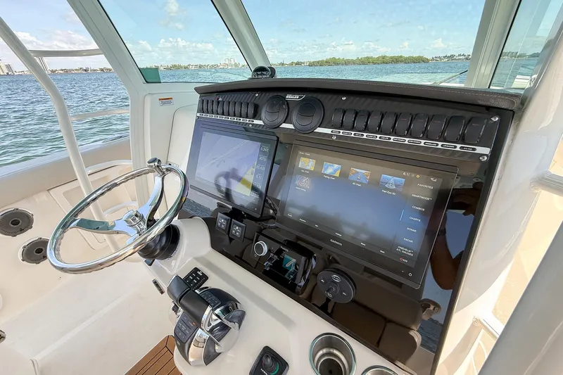  Yacht Photos Pics 2022 Boston Whaler 380 Outrage helm with advanced navigation displays and controls.