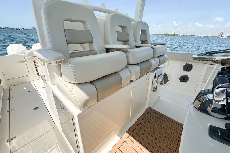  Yacht Photos Pics 2022 Boston Whaler 380 Outrage boat interior with luxurious seating and helm controls.