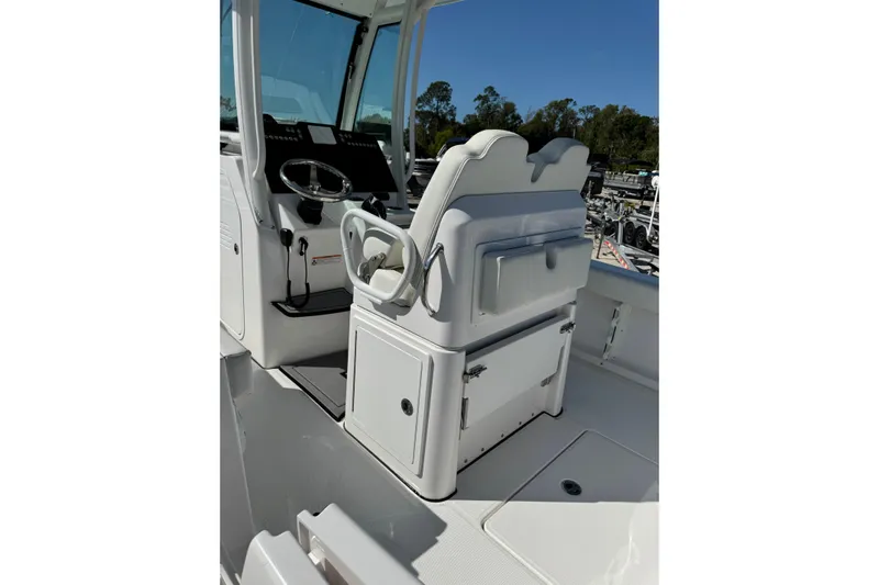  Yacht Photos Pics 2024 Everglades 235 Center Console boat interior with steering wheel and seating.